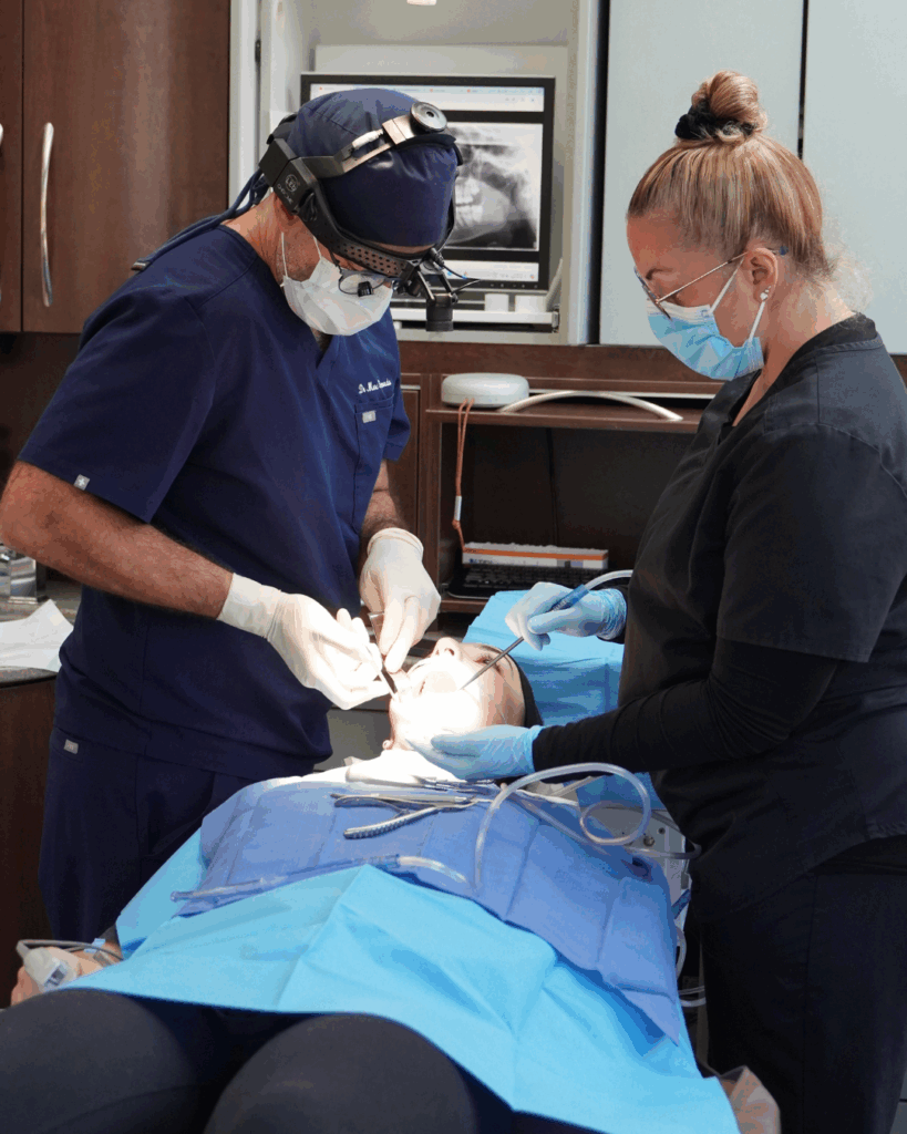 Surgeon performing wisdom teeth extraction