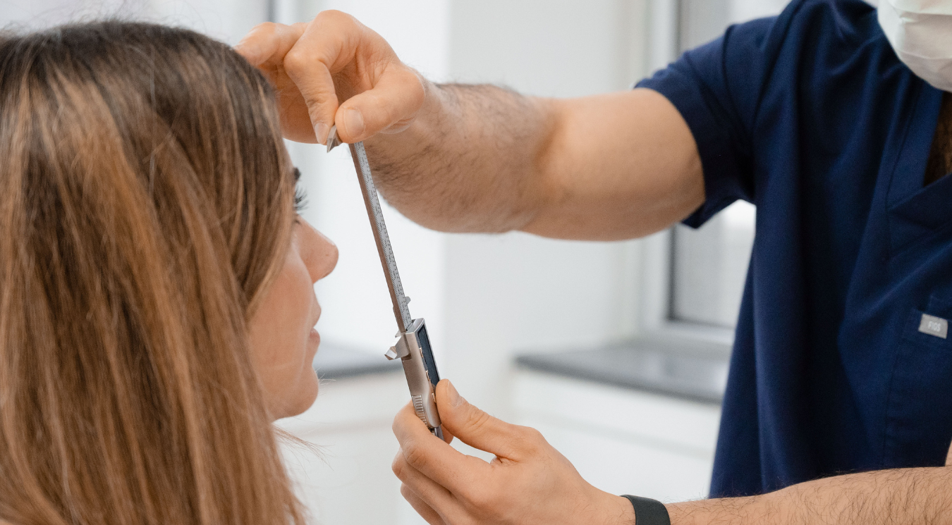 Maxillofacial surgeon measuring jaw alignment