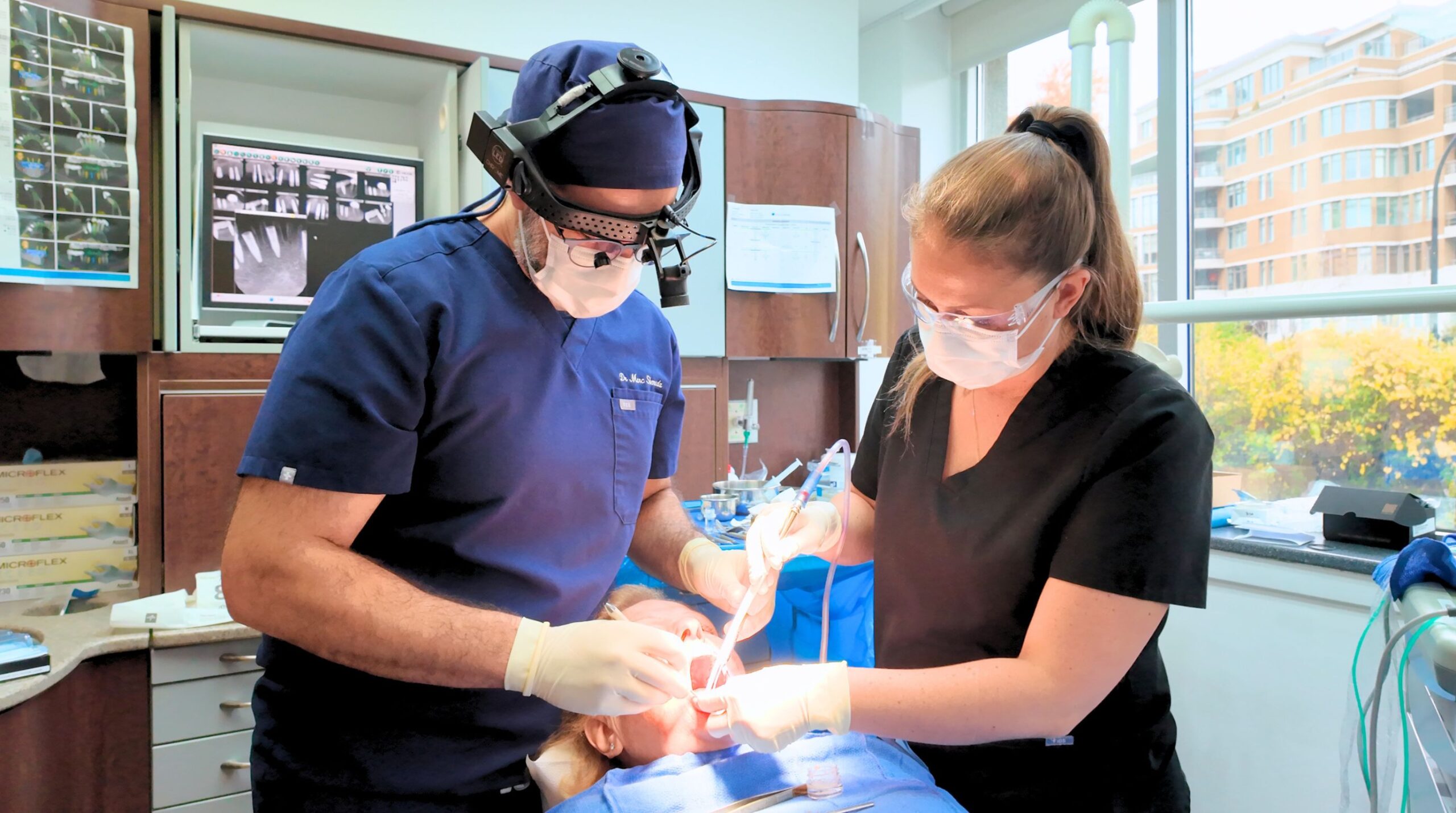 Oral surgeon performing a dental implant procedure in Montreal 