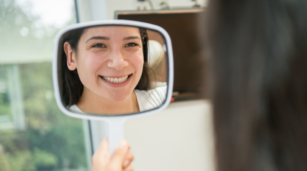 Patient smiling confidently after dental implant treatment with a natural-looking restored smile