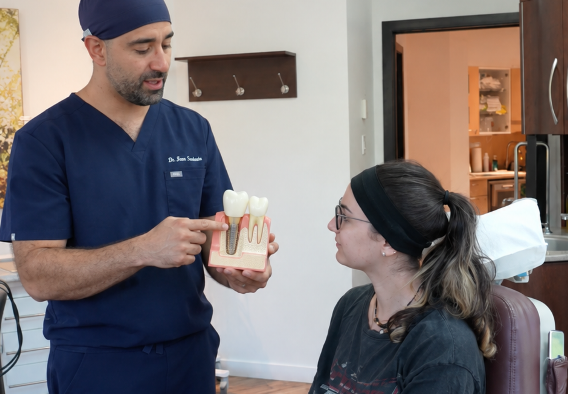 Patient discussing long-term tooth replacement options with an oral surgeon. 